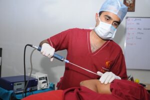 Dr. Aniketh performing liposuction on a patient