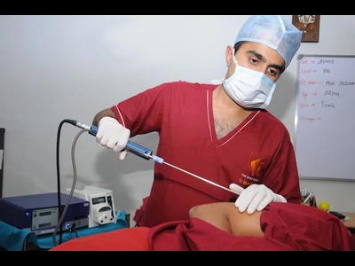 Dr. Aniketh performing liposuction on a patient