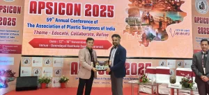 Dr. Aniketh being honoured with a certificate for his presentation on migraine surgery